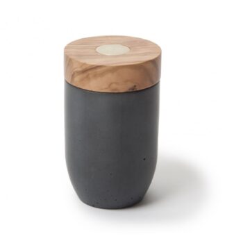 Le Moulin à sel et poivre en béton - bois d'olivier se compose d'un corps cylindrique noir mat et d'un couvercle rond et plat en bois d'olivier avec un accent métallique central, sur fond blanc.