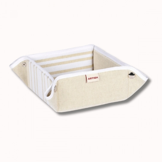 Le Paniere 17x17x8 cm (4 coloris) est un plateau en tissu rayé beige et blanc avec des coins renforcés, des œillets métalliques et une étiquette "ARTIGA", présenté sur un fond blanc uni.