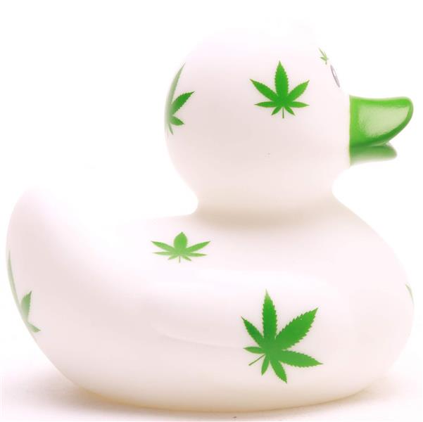 Un canard de bain « Baby Garçon » en caoutchouc, de couleur blanche, orné de motifs représentant des feuilles de cannabis vertes et doté d'un bec vert, présenté sur un fond blanc uni.