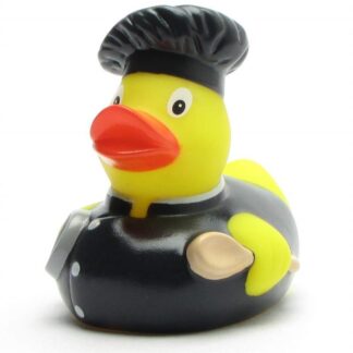 Un canard de bain « Baby Garçon » : un canard en caoutchouc jaune déguisé en chef cuisinier, coiffé d’une toque noire et vêtu d’une veste noire à boutons blancs, tenant une louche.