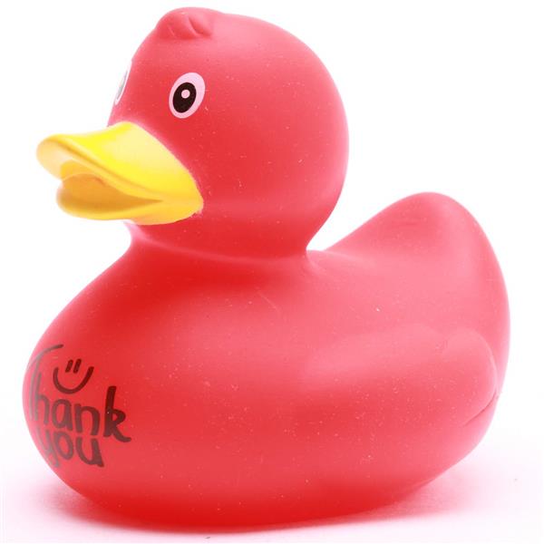 Un canard en caoutchouc rouge avec un bec jaune et un visage souriant. Les mots « Merci » accompagnés d'un smiley sont imprimés en noir sur le côté. Le fond est blanc.