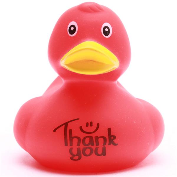 Un canard en caoutchouc rouge avec un bec jaune, sur la poitrine duquel sont imprimés les mots « Merci » et un smiley.