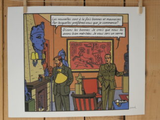 Deux hommes en costume, Blake et Mortimer, discutent dans une pièce ornée d’objets anciens et d’œuvres d’art. L’un d’eux tient un verre à la main, tandis qu’un texte en français apparaît au-dessus d’eux dans une bulle de bande dessinée. L’arrière-plan met en valeur des statues et un imposant relief rouge qui orne le mur. Cette scène figure sur la lithographie « André Juillard – Blake et Mortimer : Les Nouvelles » (40 × 50 cm).