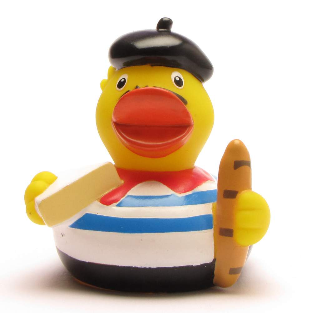 Un canard en caoutchouc, vêtu d'une chemise rayée, d'une écharpe rouge et d'un béret, tient une baguette dans une aile et un morceau de fromage dans l'autre, imitant ainsi un stéréotype français.