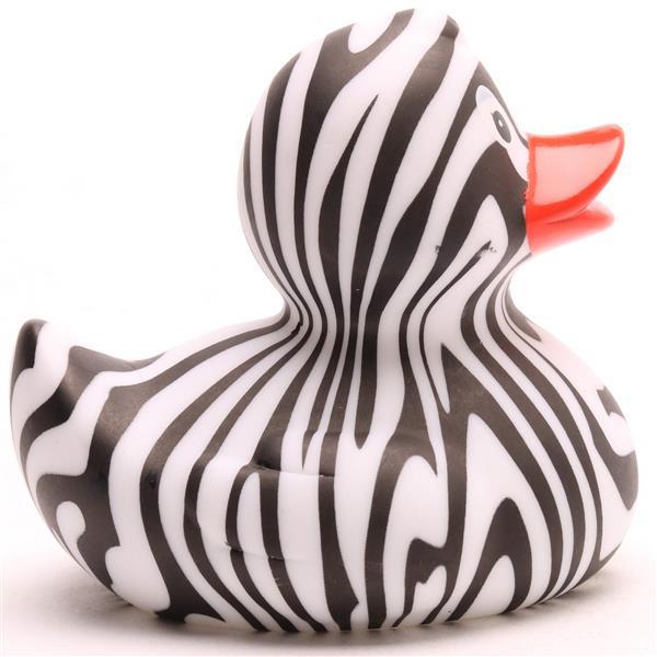 Un canard en caoutchouc aux rayures noires et blanches rappelant celles d'un zèbre, doté d'un bec orange, représenté de profil, tourné vers la droite.