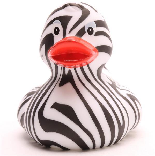 Un canard en caoutchouc aux rayures zébrées noires et blanches et au bec orange, photographié sur fond blanc.