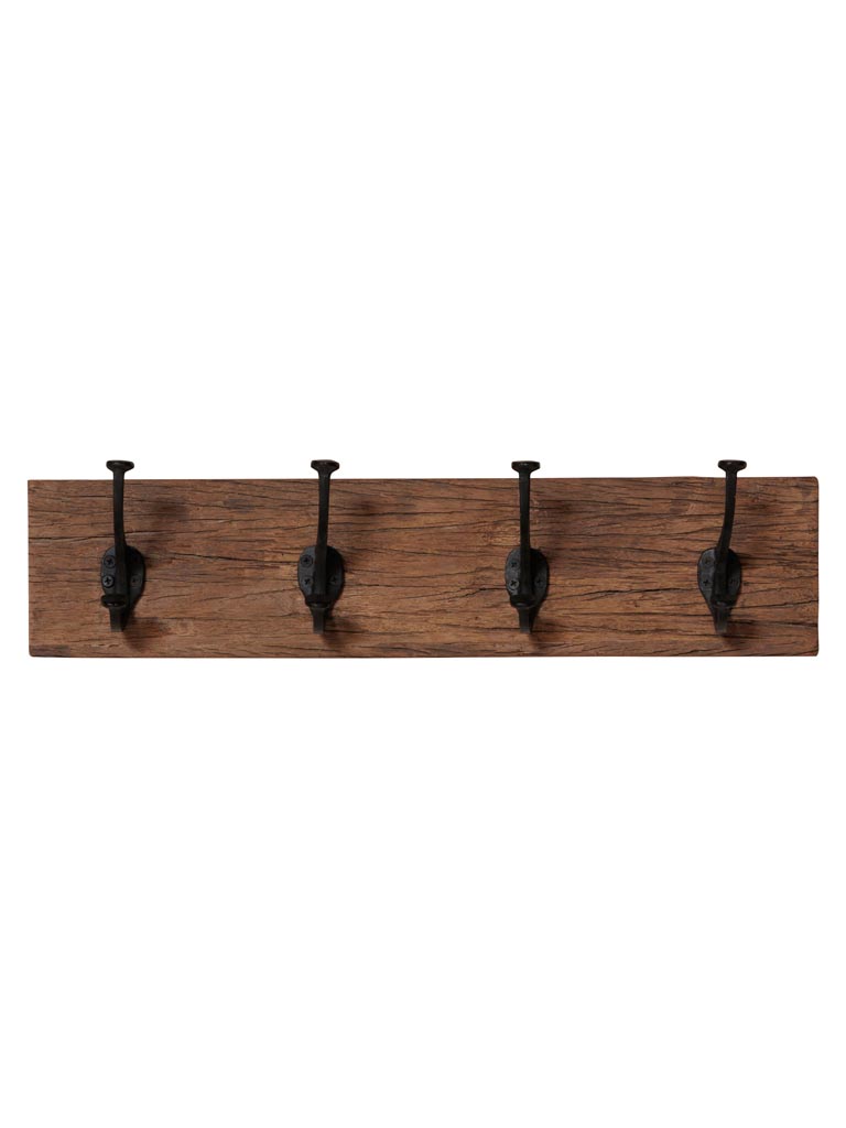 Le porte-manteau mural « Cheyenne » en bois recyclé – 4 crochets est un porte-manteau mural fabriqué à partir de bois de récupération, doté de quatre crochets en métal noir espacés de manière régulière sur toute sa longueur.