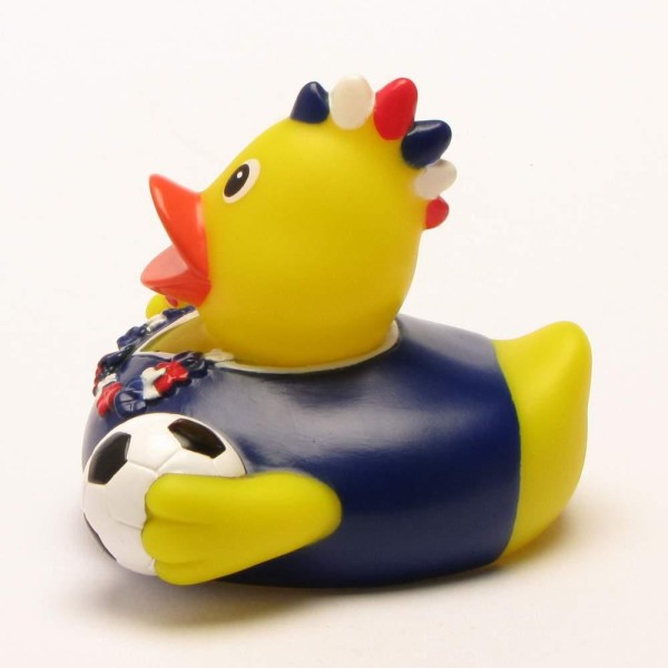 Canard de bain « Fan de football France » : canard en caoutchouc jaune portant un maillot de foot bleu, tenant un ballon de foot et arborant une crête iroquoise rouge, blanche et bleue.